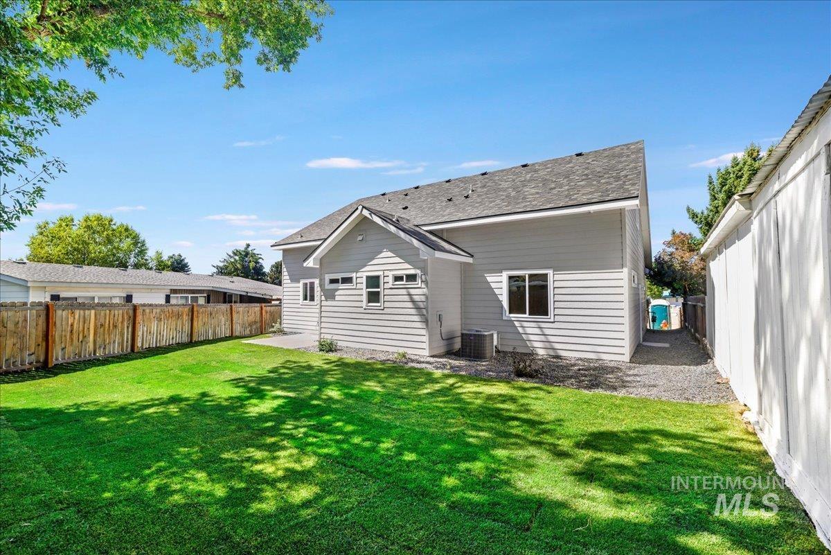Rear view of property with a fenced backyard