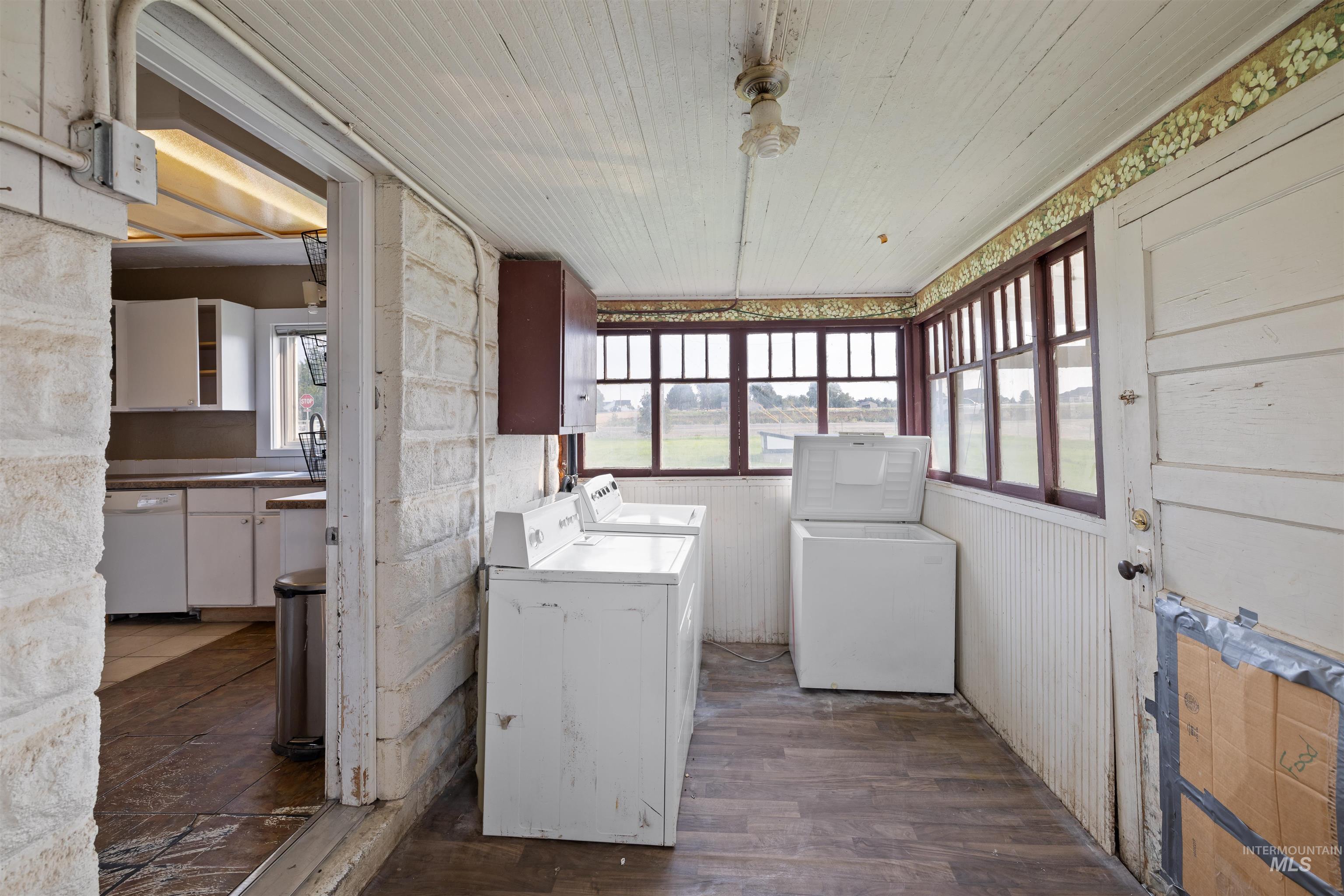Laundry area featuring washer and clothes dryer and dark wood finished floors