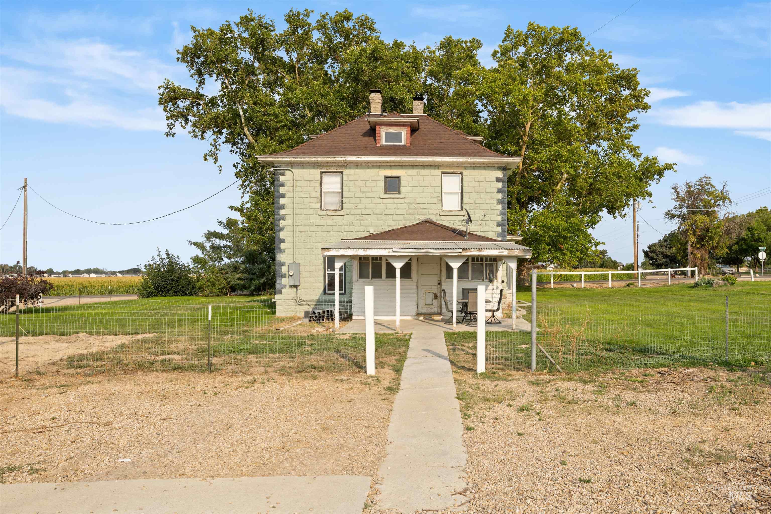 Traditional style home featuring a chimney and roof with shingles