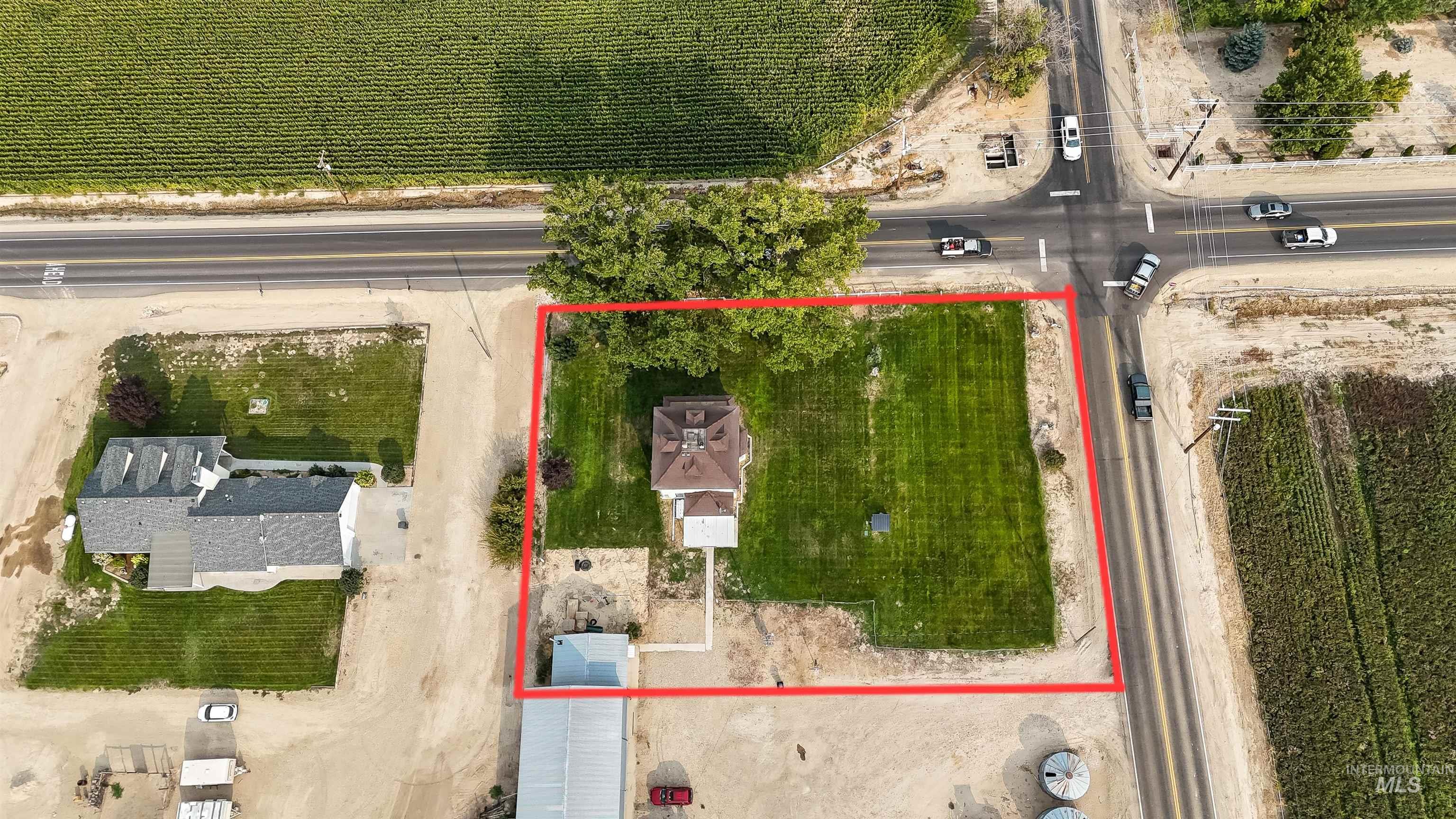 Aerial view of property and surrounding area featuring property boundaries highlighted