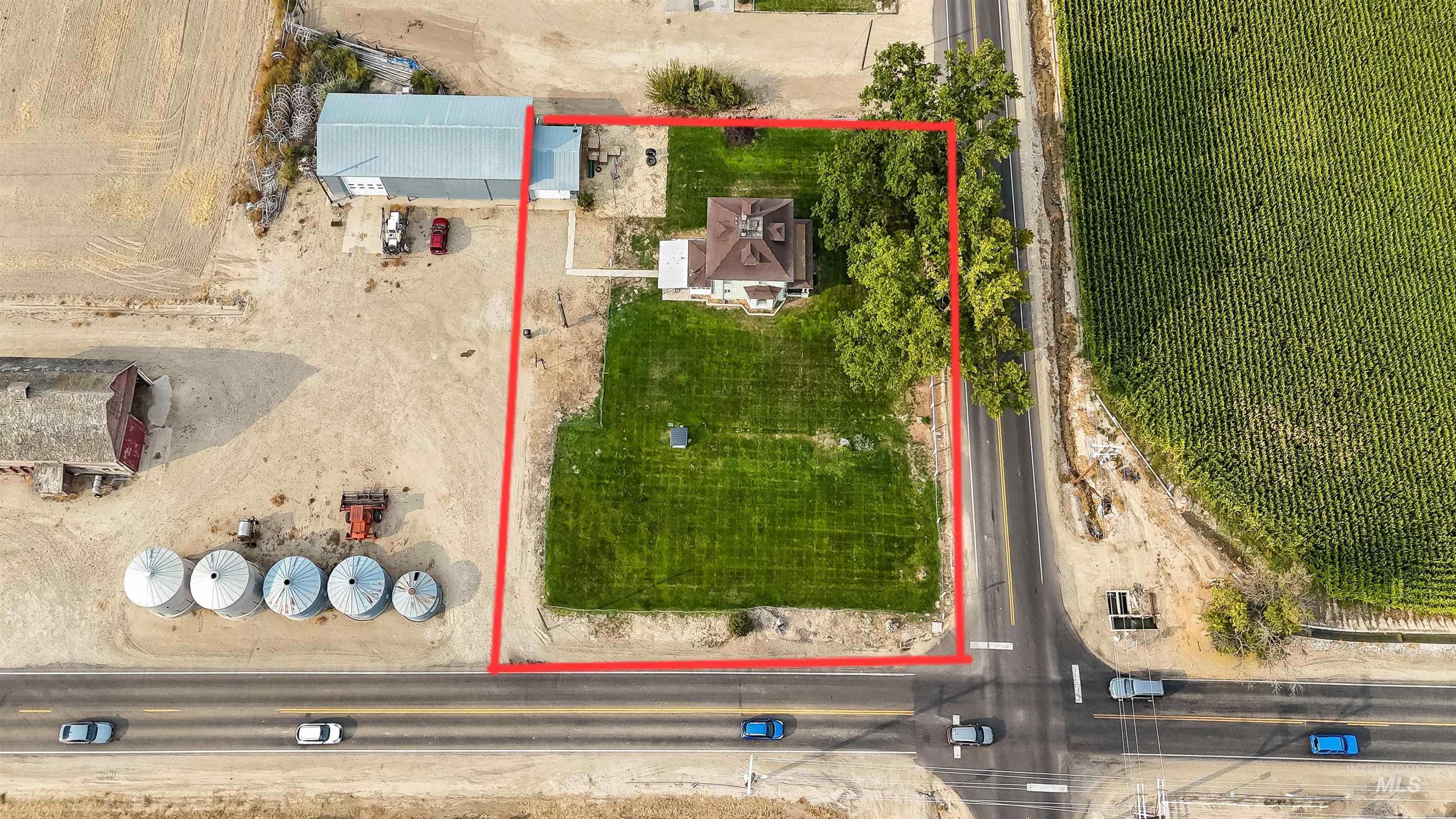 Aerial view of sparsely populated area with property parcel outlined