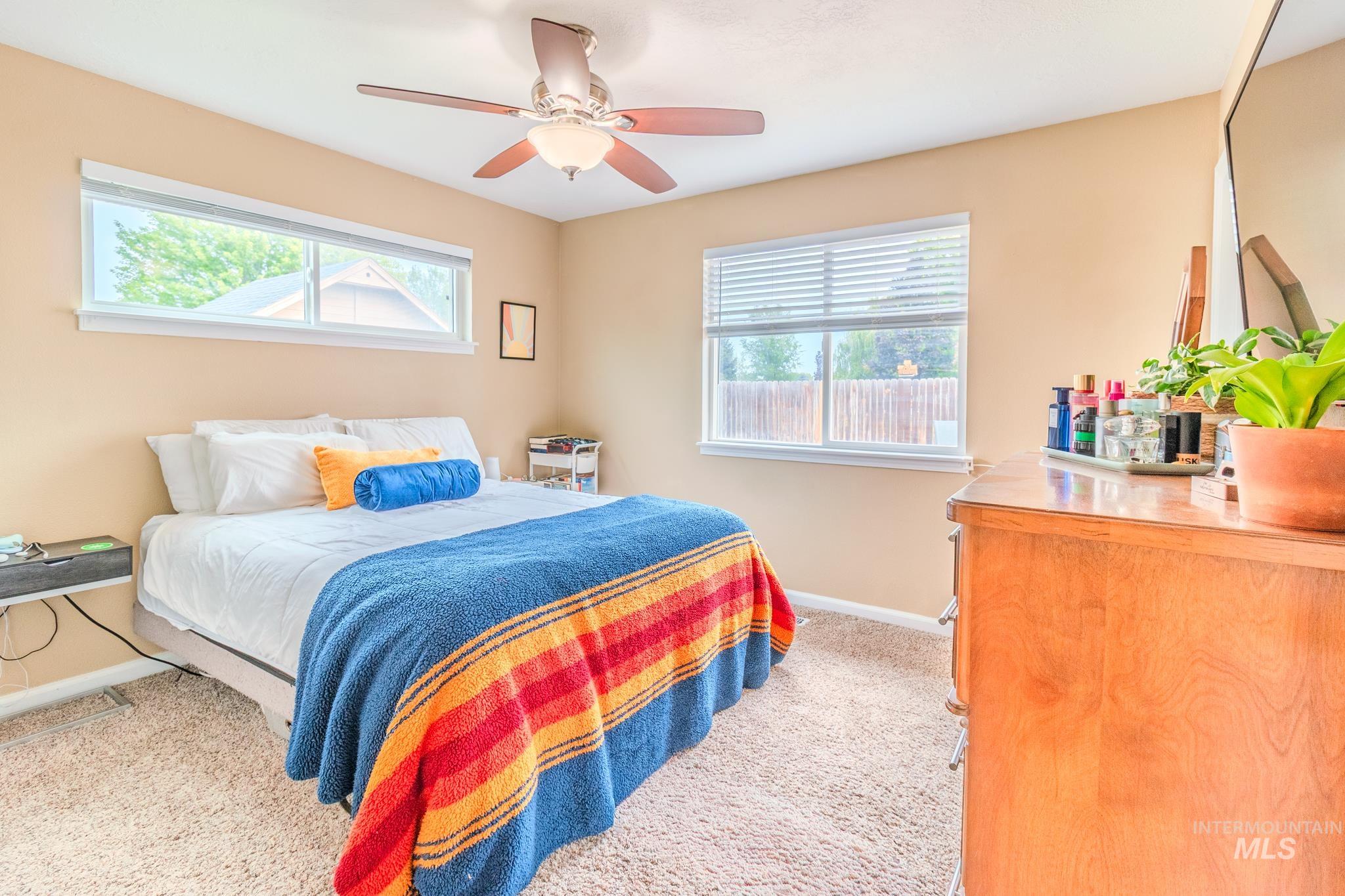 Bedroom featuring light colored carpet and ceiling fan
