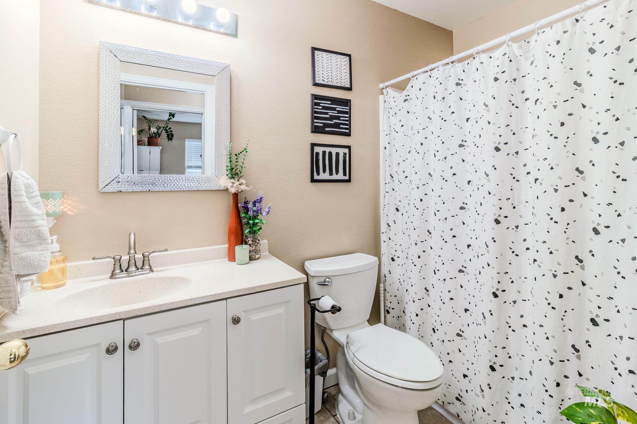 Full bathroom featuring vanity and a shower with shower curtain