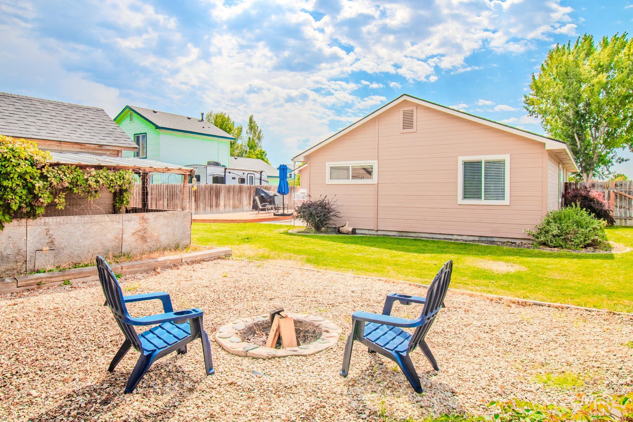 View of yard with an outdoor fire pit and a patio area