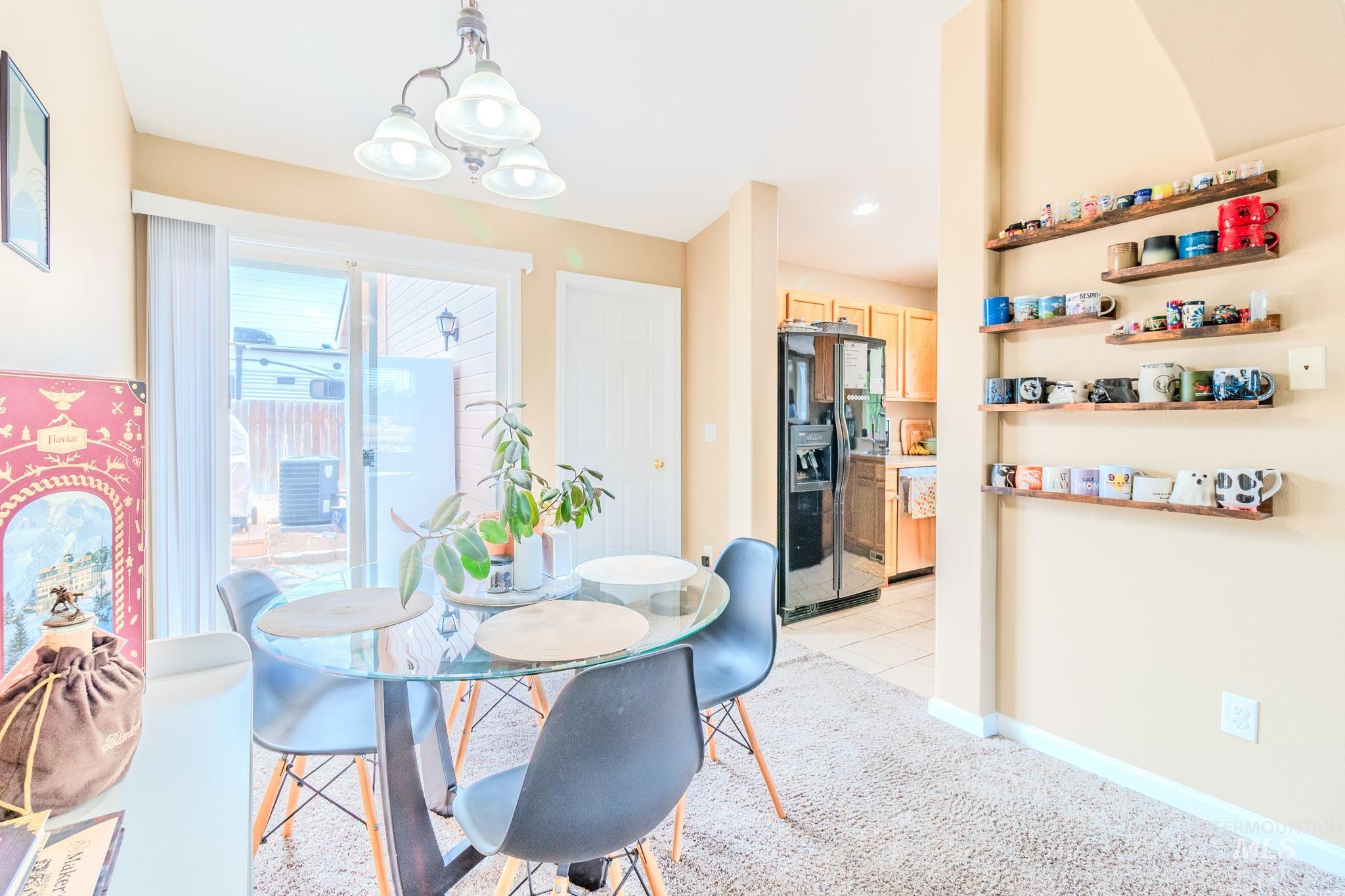 Dining room featuring light carpet and a chandelier