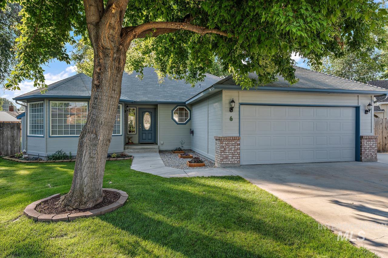 Ranch-style house with driveway, an attached garage, and brick siding