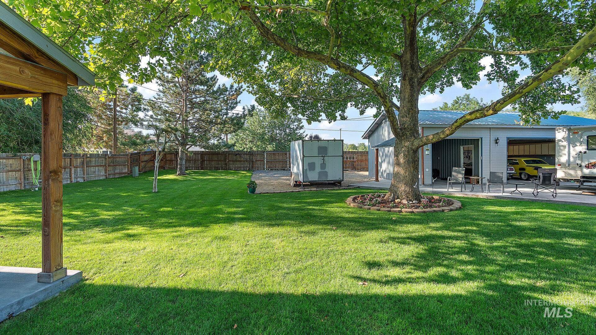 Fenced backyard featuring a patio and a storage shed