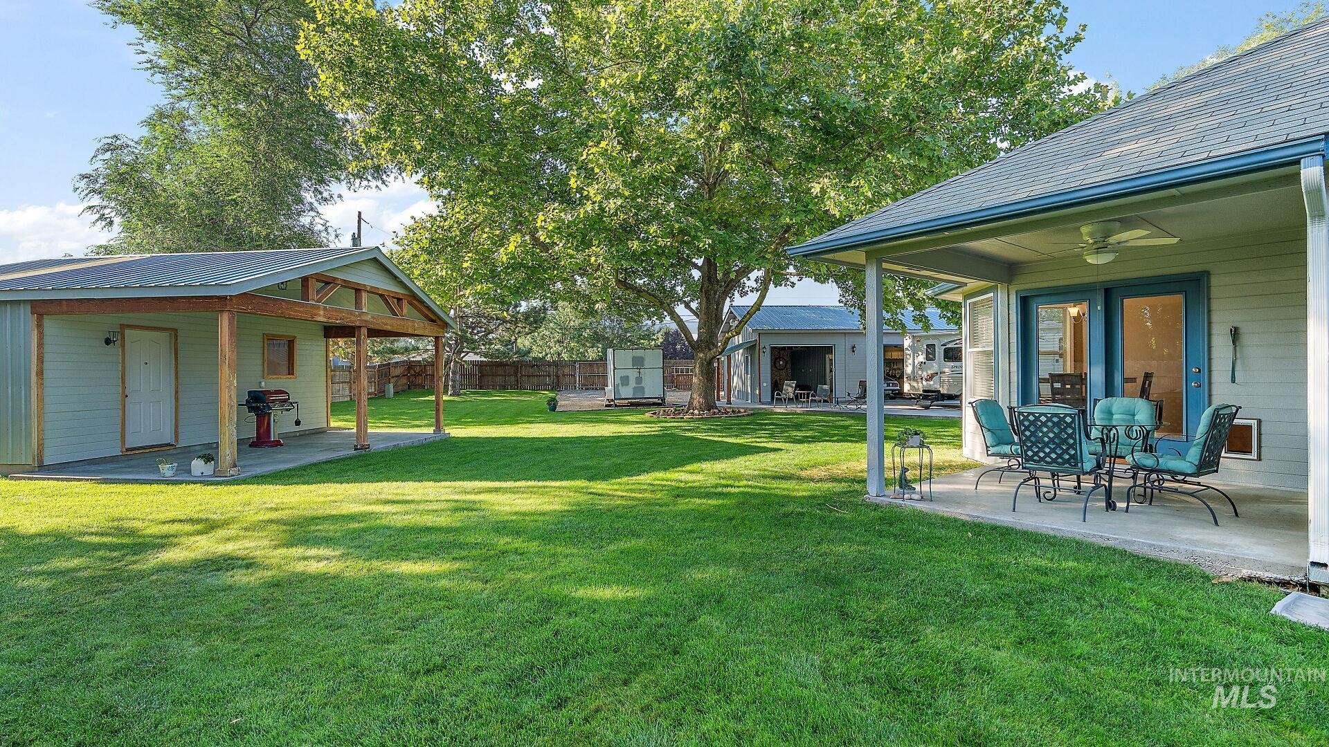 View of yard with a patio, ceiling fan, and an outdoor structure