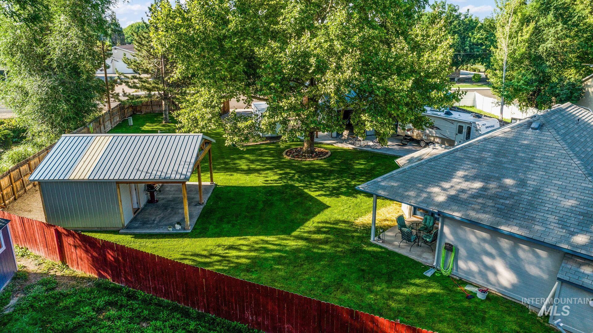 Fenced backyard with a patio area and an outdoor structure