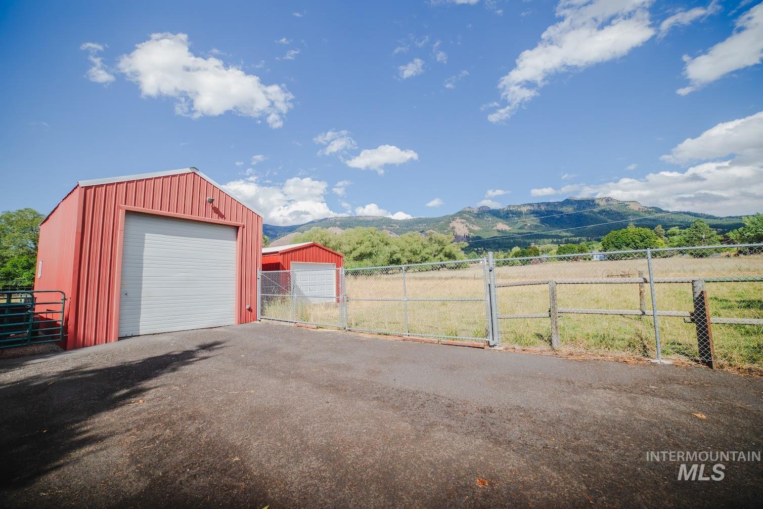 Detached garage featuring a mountain view and a gate