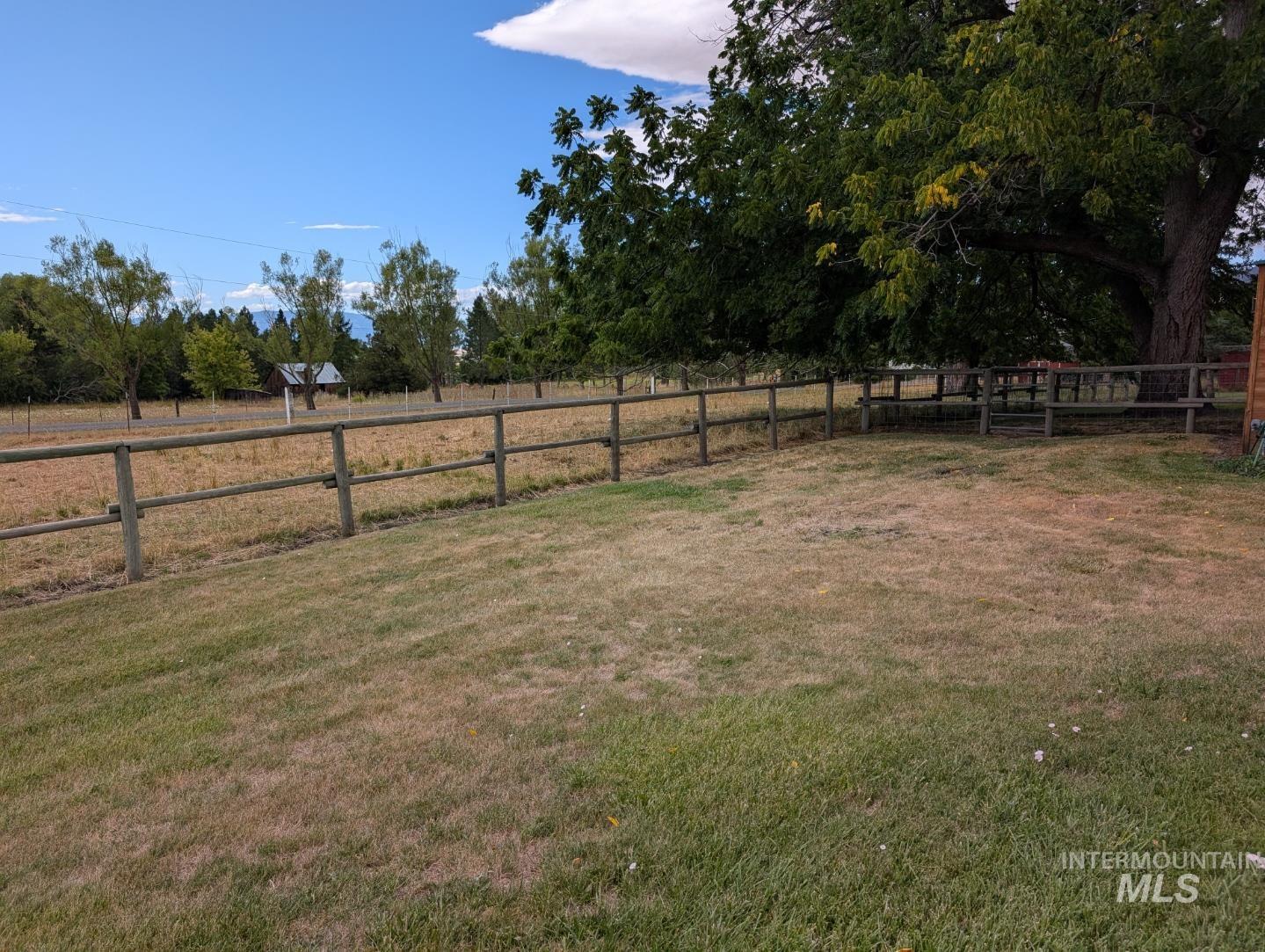 View of yard with a rural view