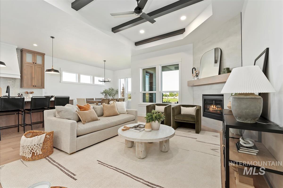 Living area featuring light wood-style floors, plenty of natural light, a tile fireplace, and recessed lighting