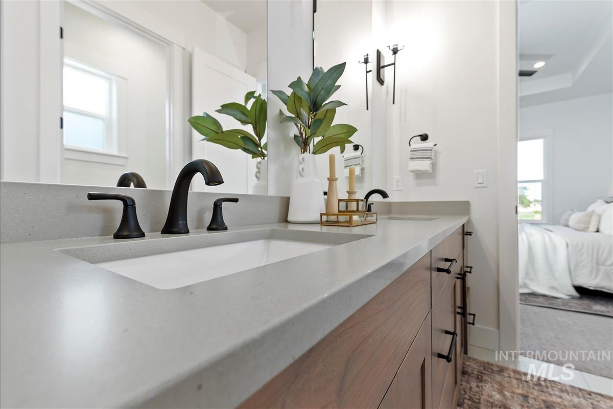 Ensuite bathroom featuring plenty of natural light and double vanity