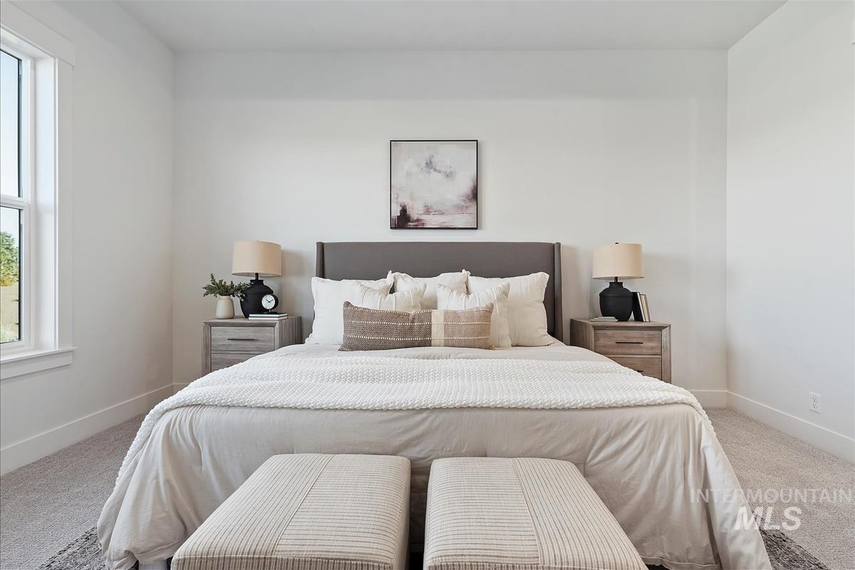 Bedroom with carpet floors and baseboards