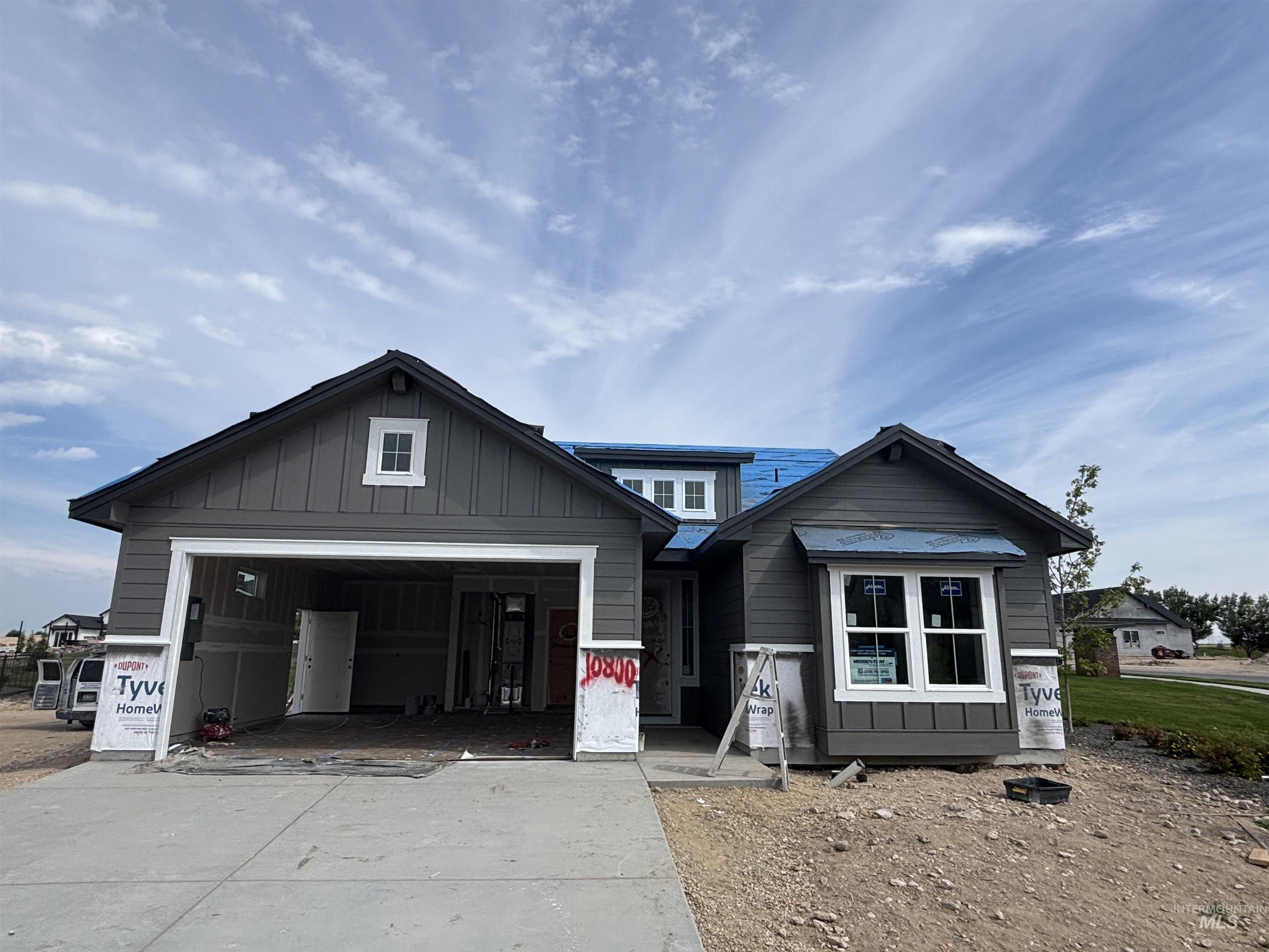 View of front of house featuring board and batten siding, concrete driveway, and an attached garage