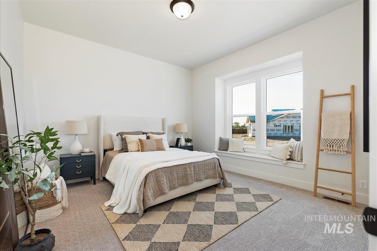 Carpeted bedroom featuring baseboards