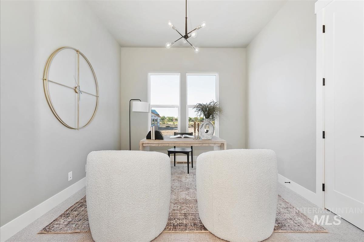 Office area featuring a chandelier and baseboards
