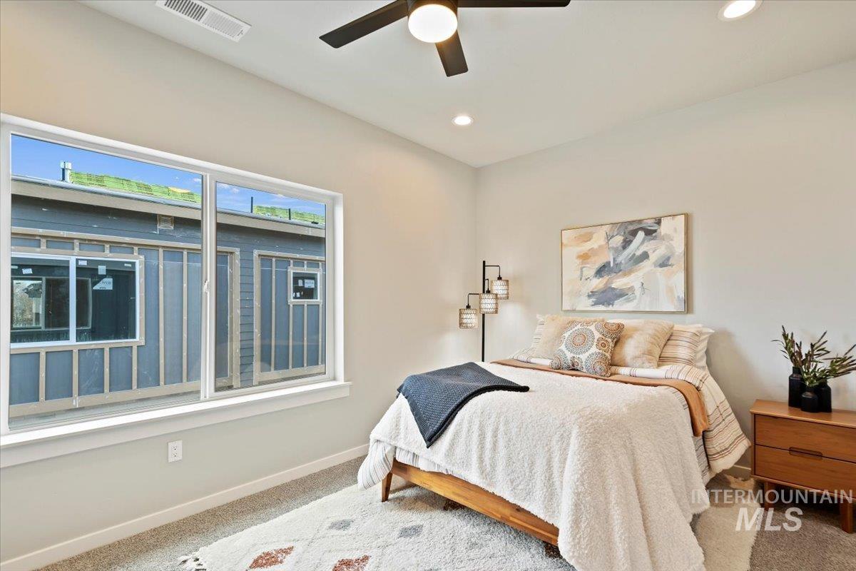 Carpeted bedroom with recessed lighting and ceiling fan