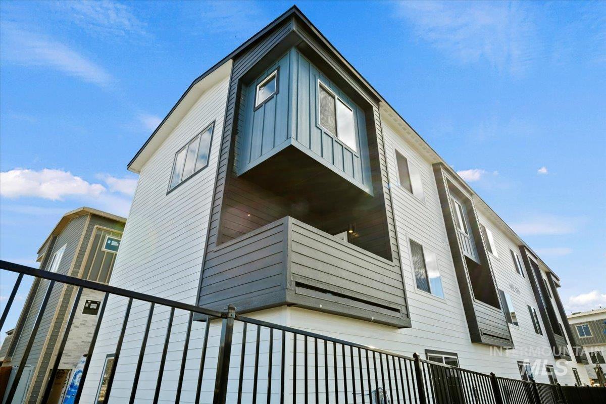 View of side of home featuring a balcony