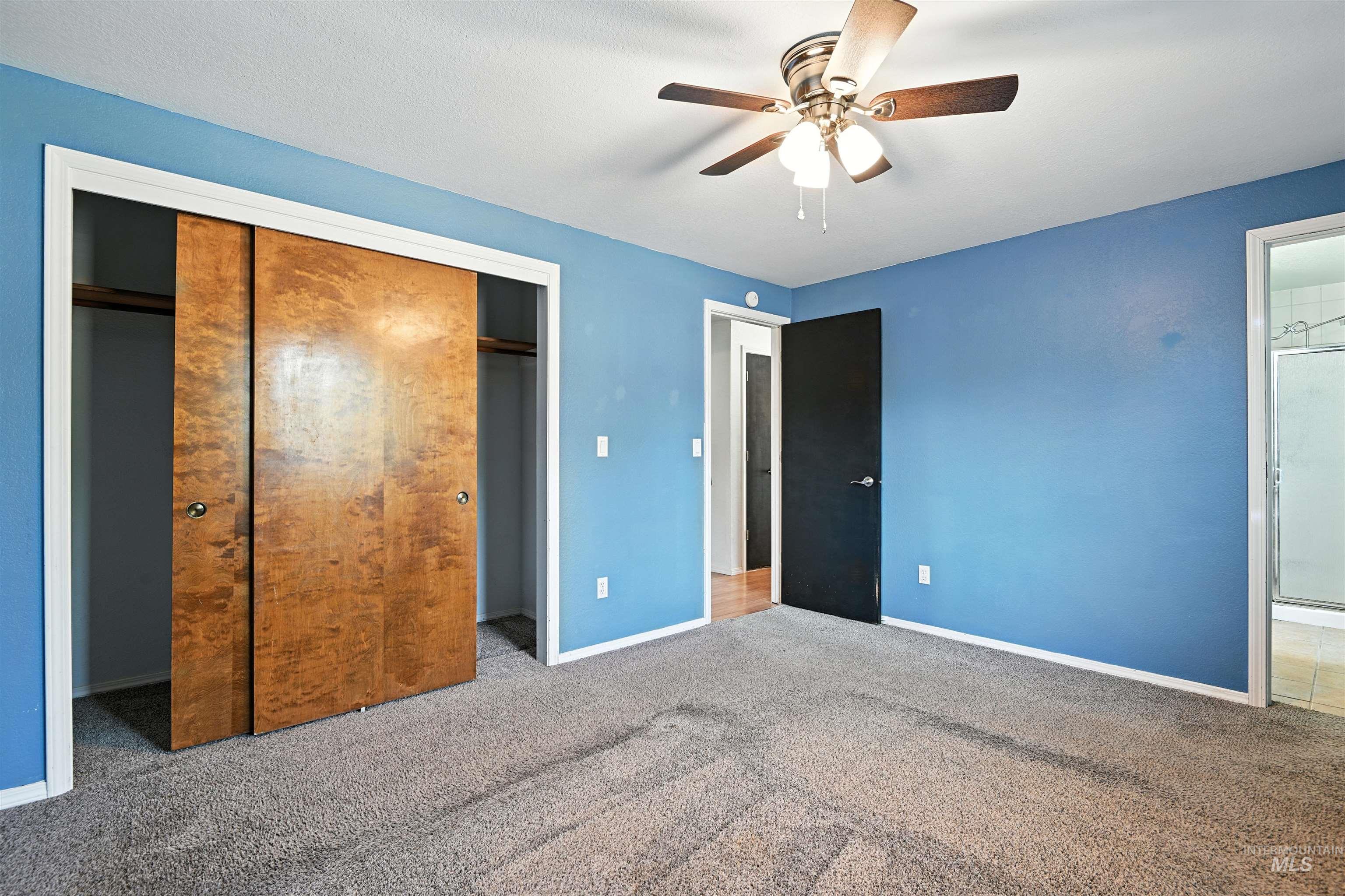 Unfurnished bedroom with a closet, carpet floors, and ceiling fan