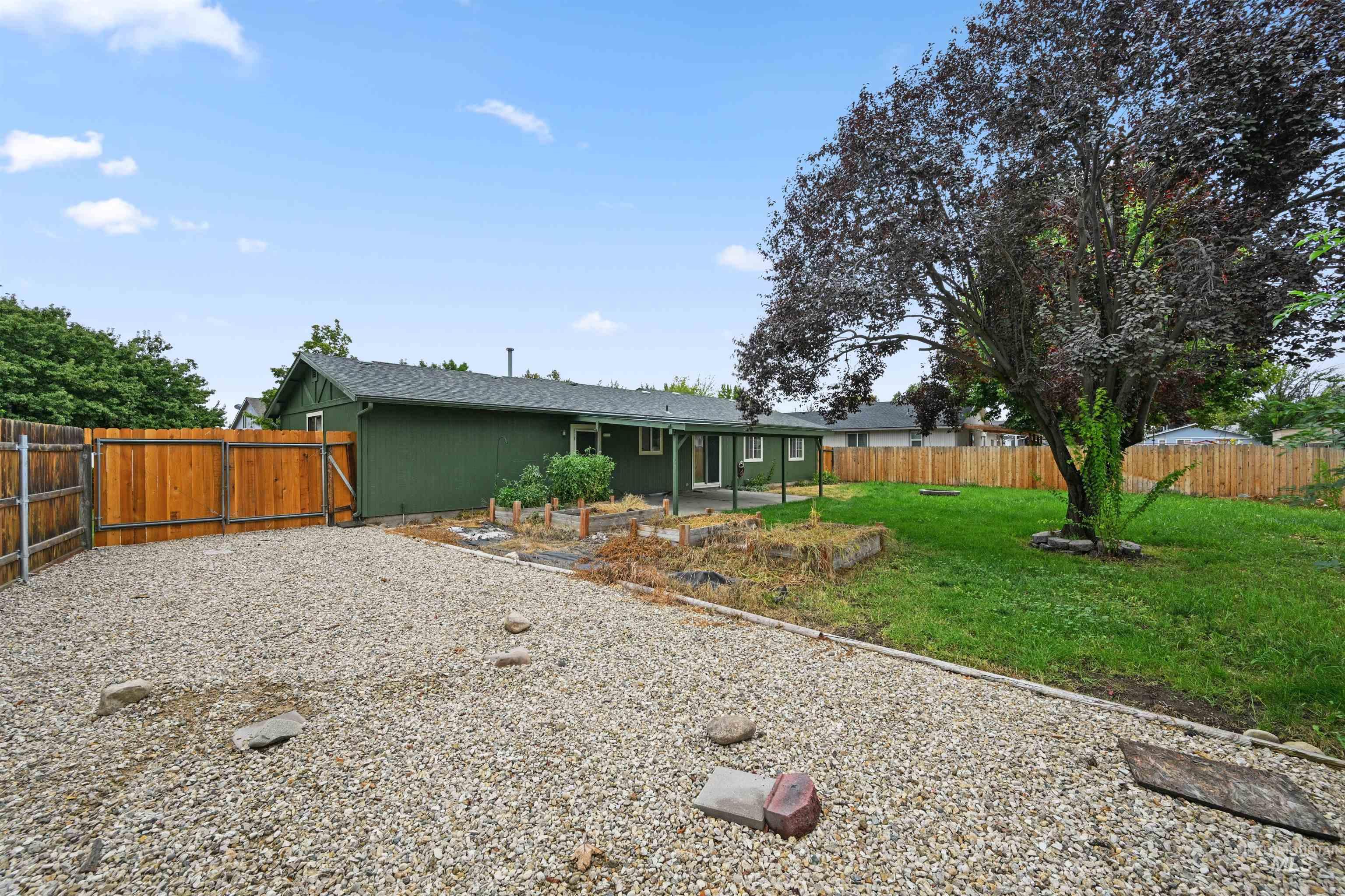 Back of house featuring a fenced backyard and a patio