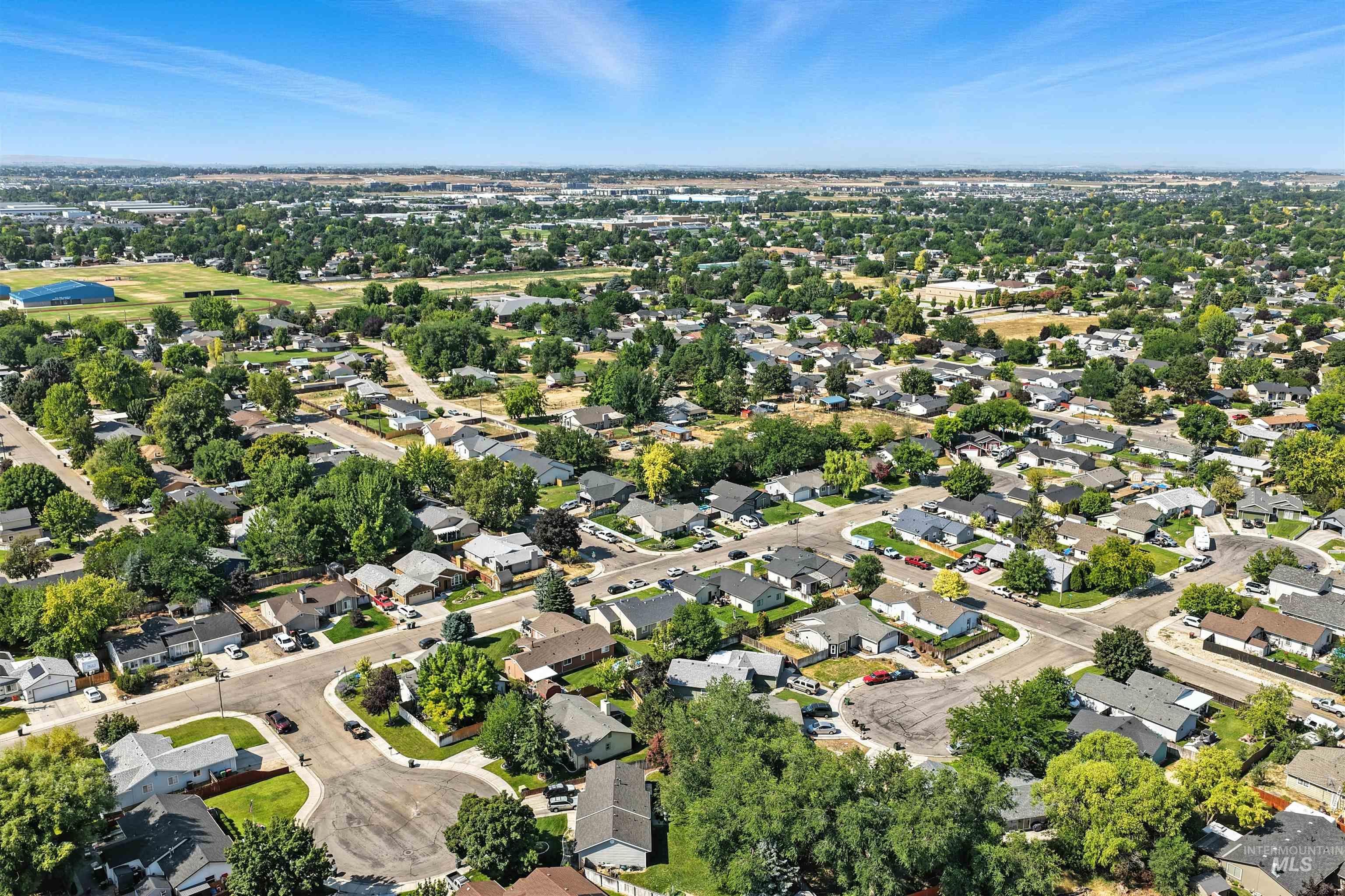 Aerial view of property's location featuring nearby suburban area