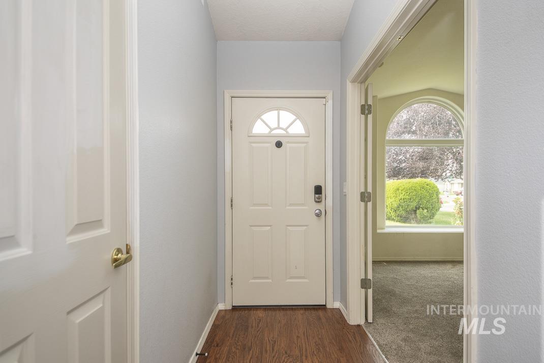 Entryway featuring baseboards and wood finished floors