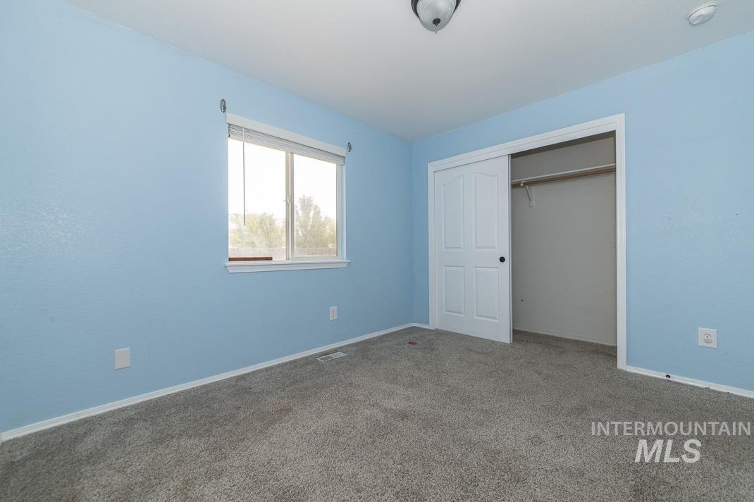 Unfurnished bedroom featuring carpet flooring and a closet