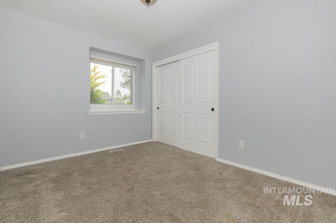 Unfurnished bedroom featuring a closet and carpet floors
