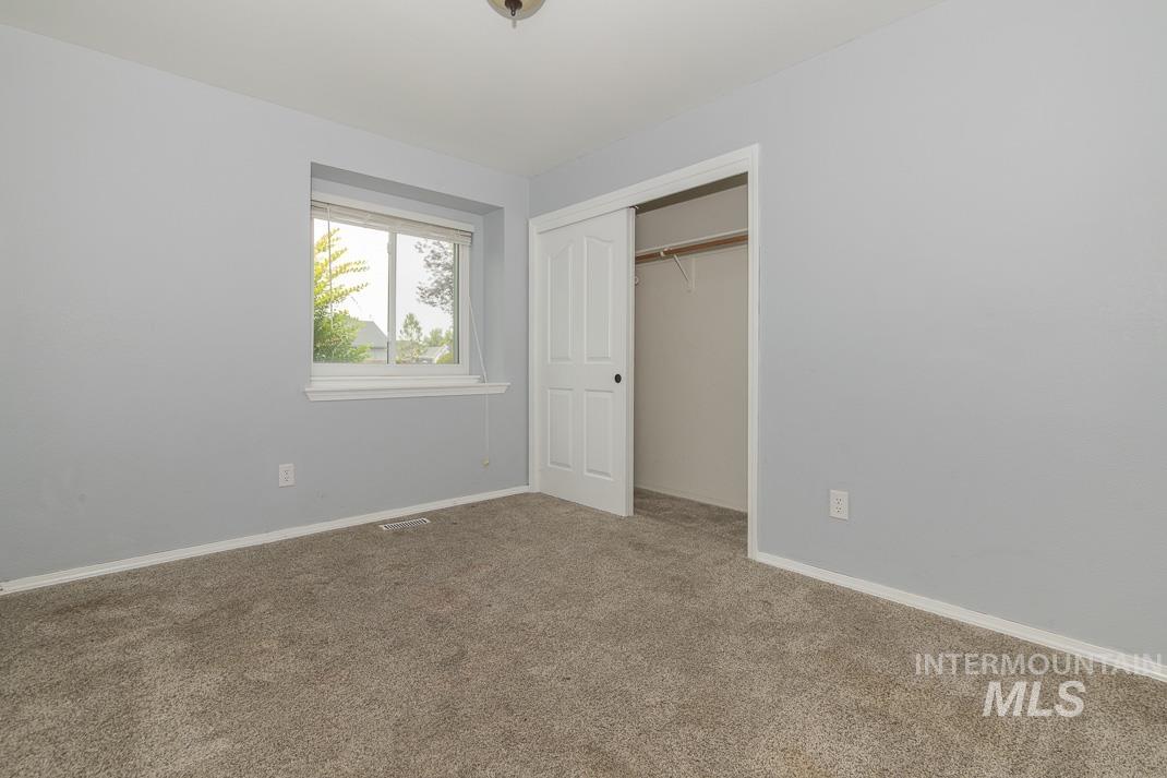 Unfurnished bedroom with carpet floors and a closet