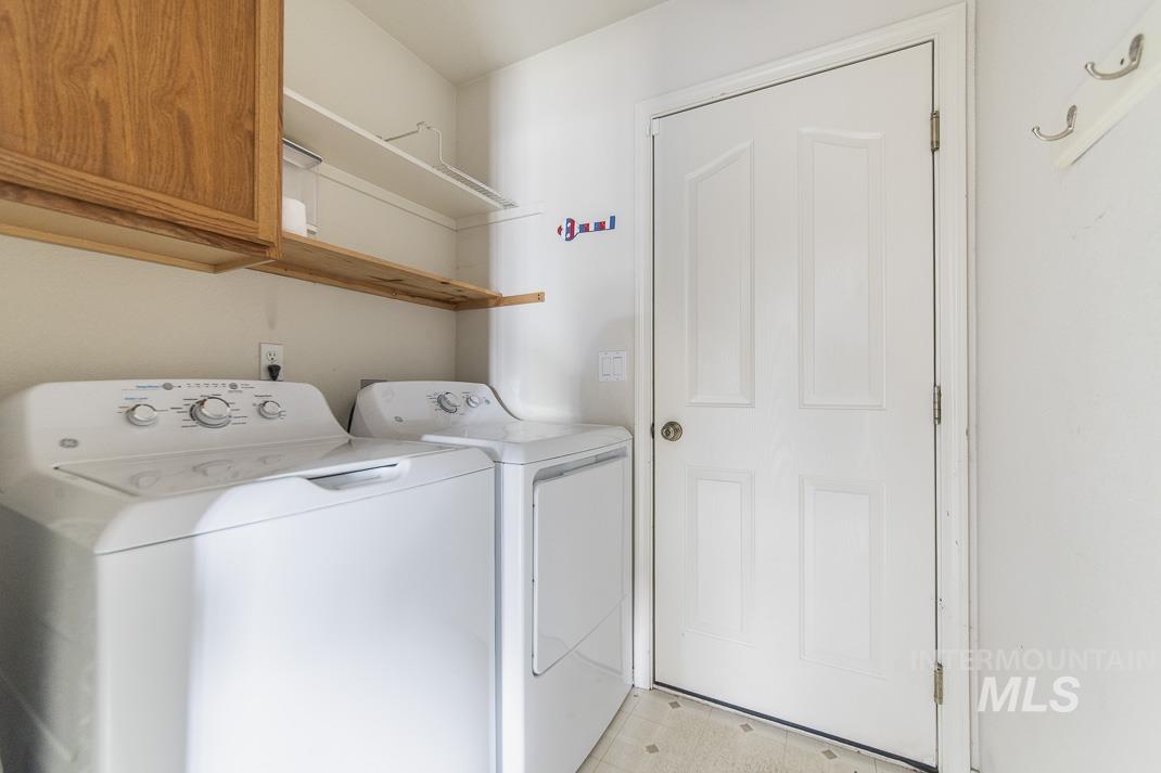 Laundry area with cabinet space and washing machine and dryer