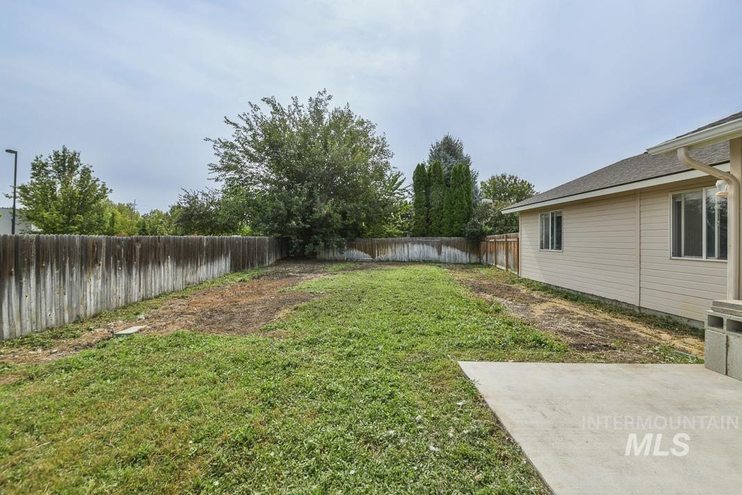 Fenced backyard featuring a patio
