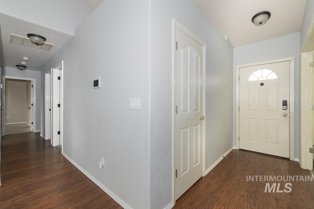 Hallway featuring dark wood-style floors