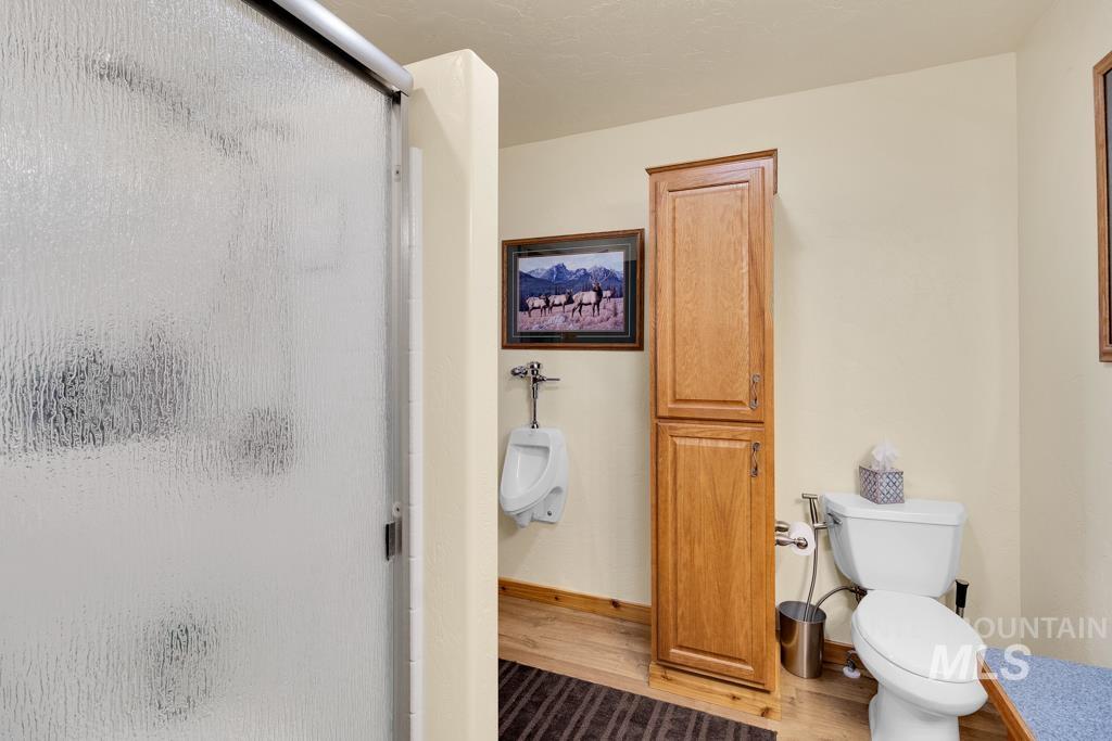 Full bathroom with a stall shower and wood finished floors