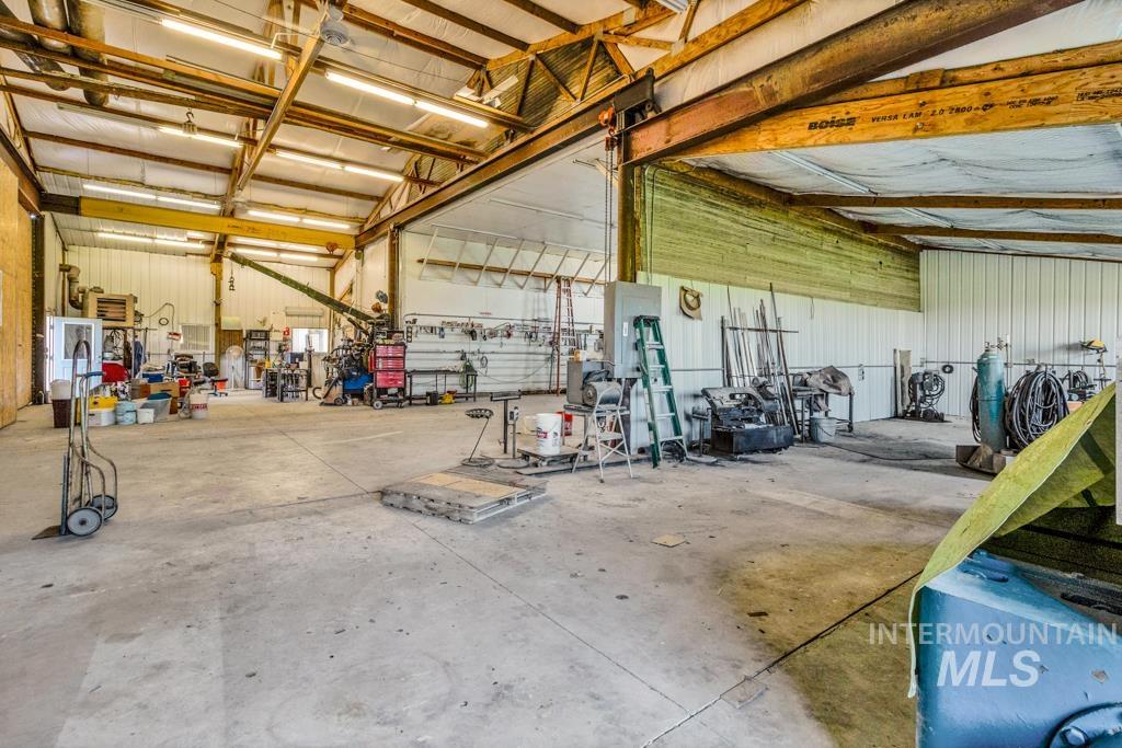 Garage featuring electric panel and metal wall
