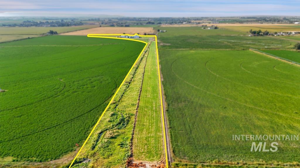 Aerial view of sparsely populated area featuring rows of crops