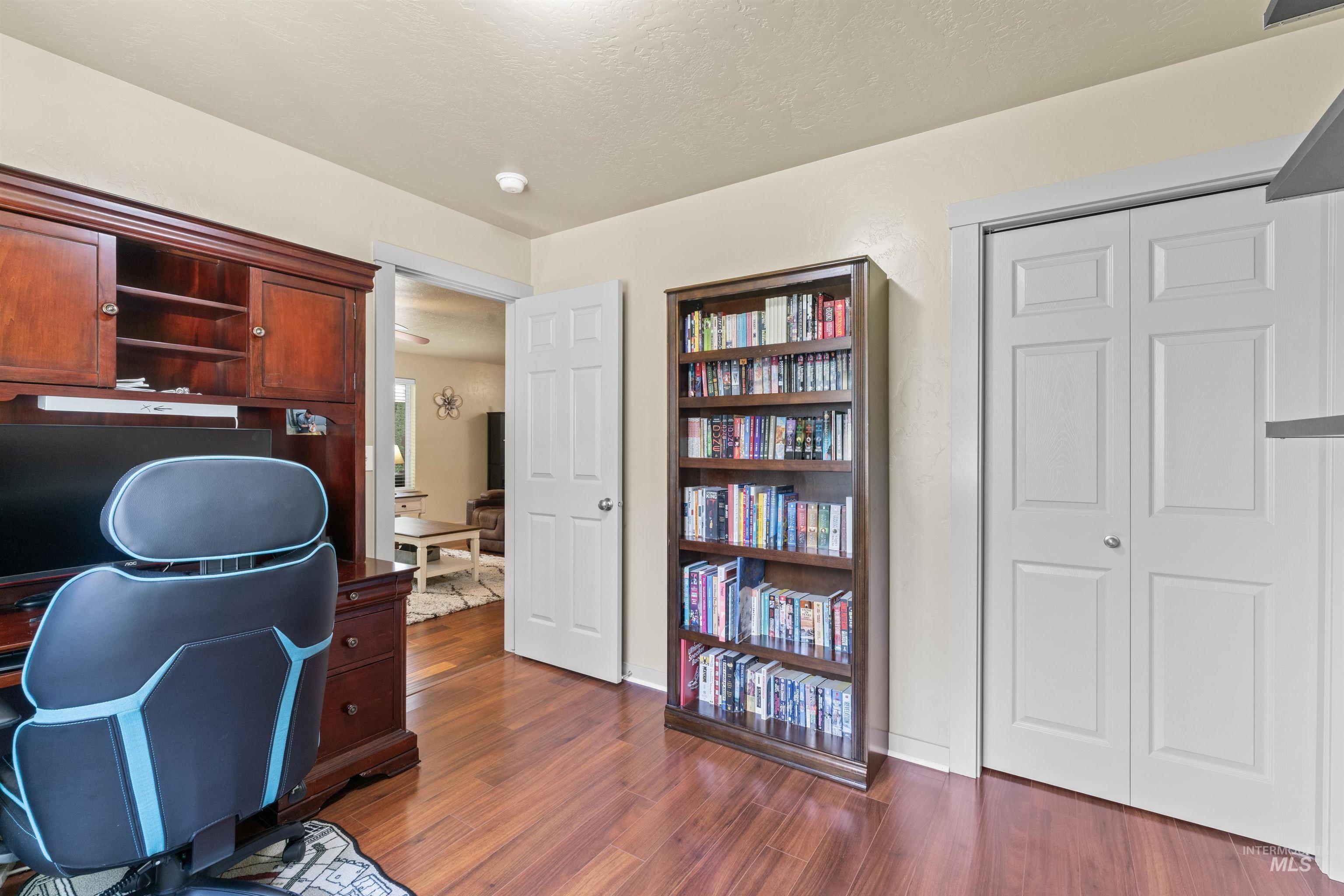 Office area featuring dark wood-style flooring