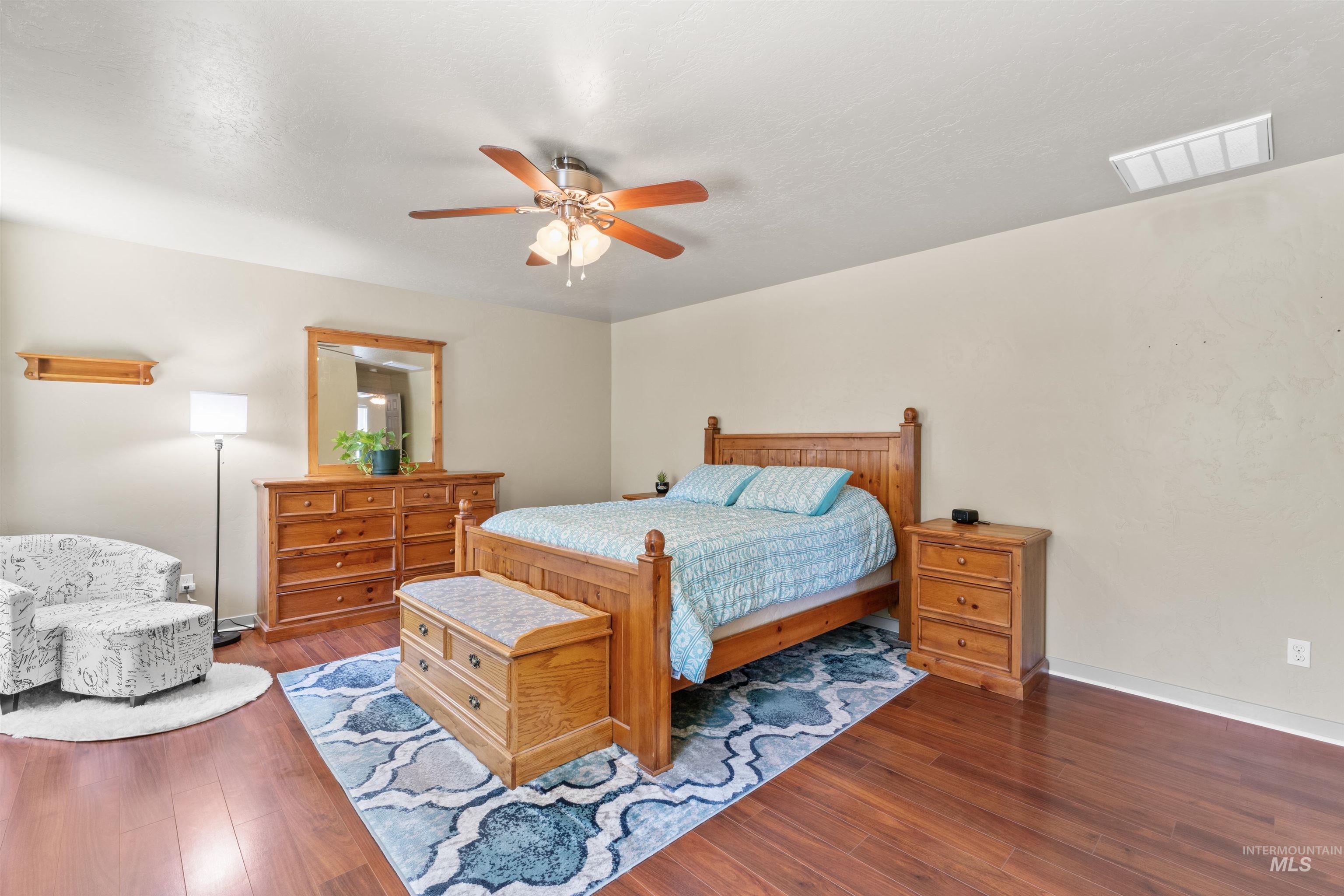 Bedroom with wood finished floors and a ceiling fan