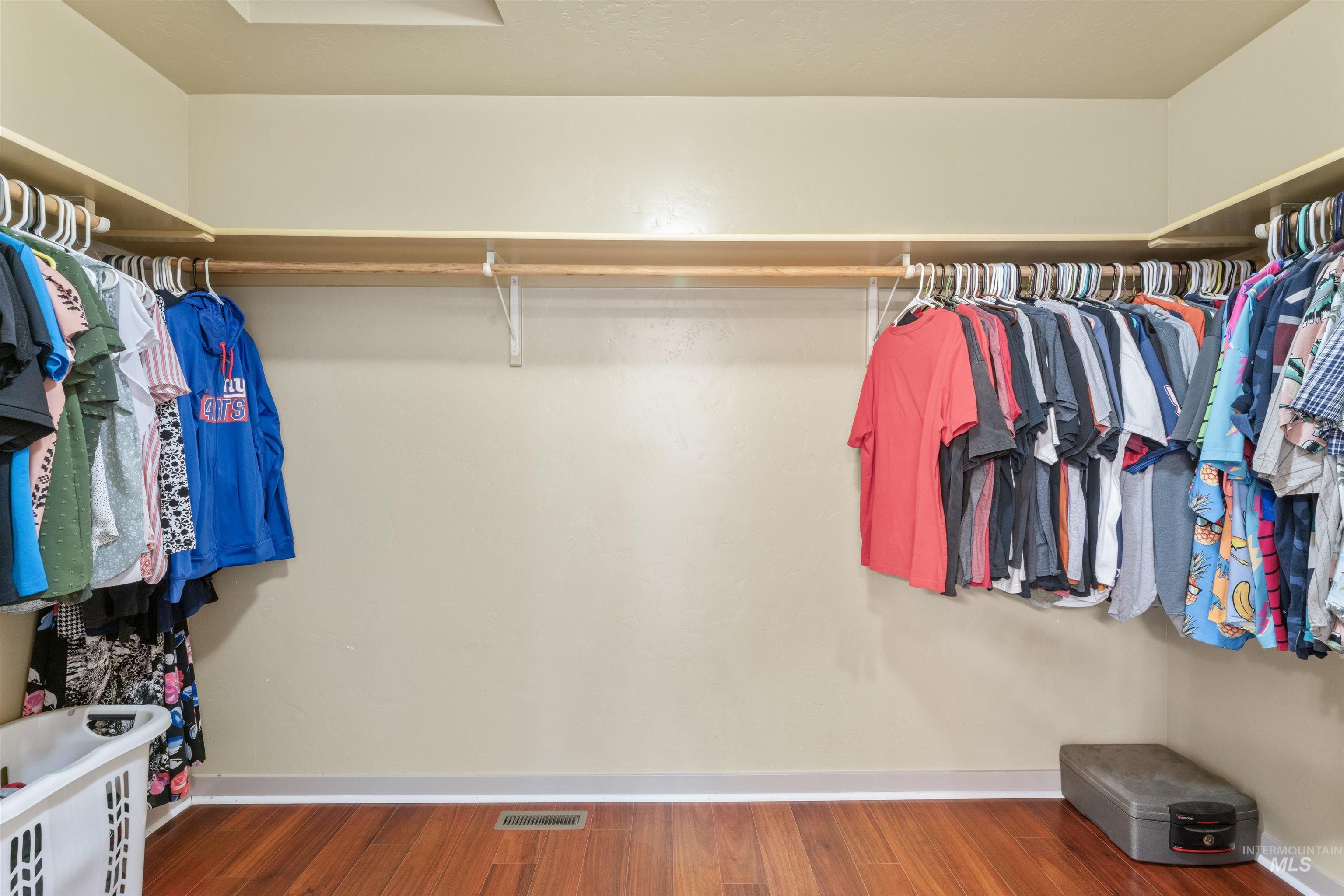 Walk in closet featuring wood finished floors