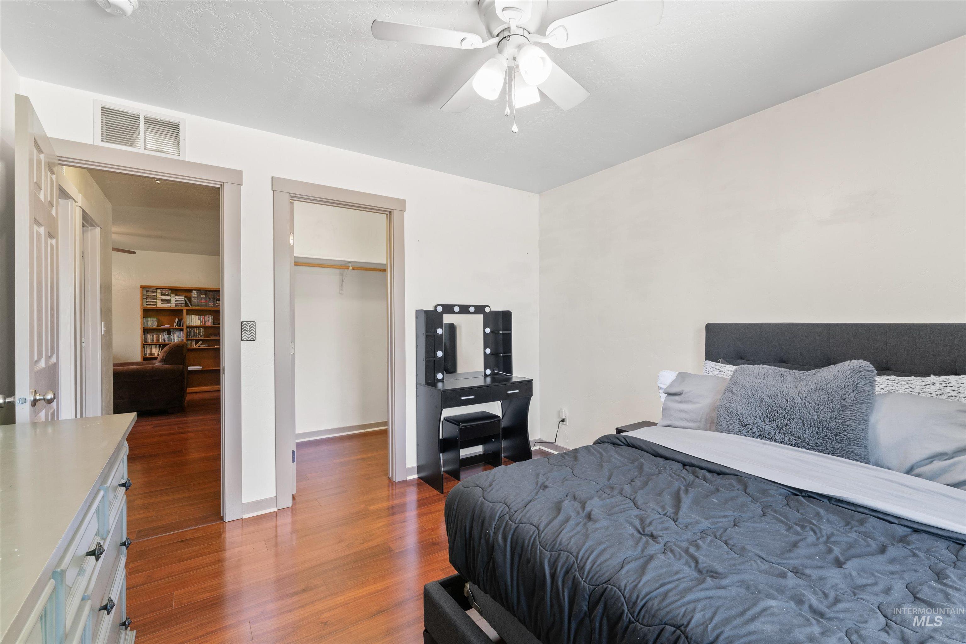 Bedroom featuring wood finished floors and a ceiling fan