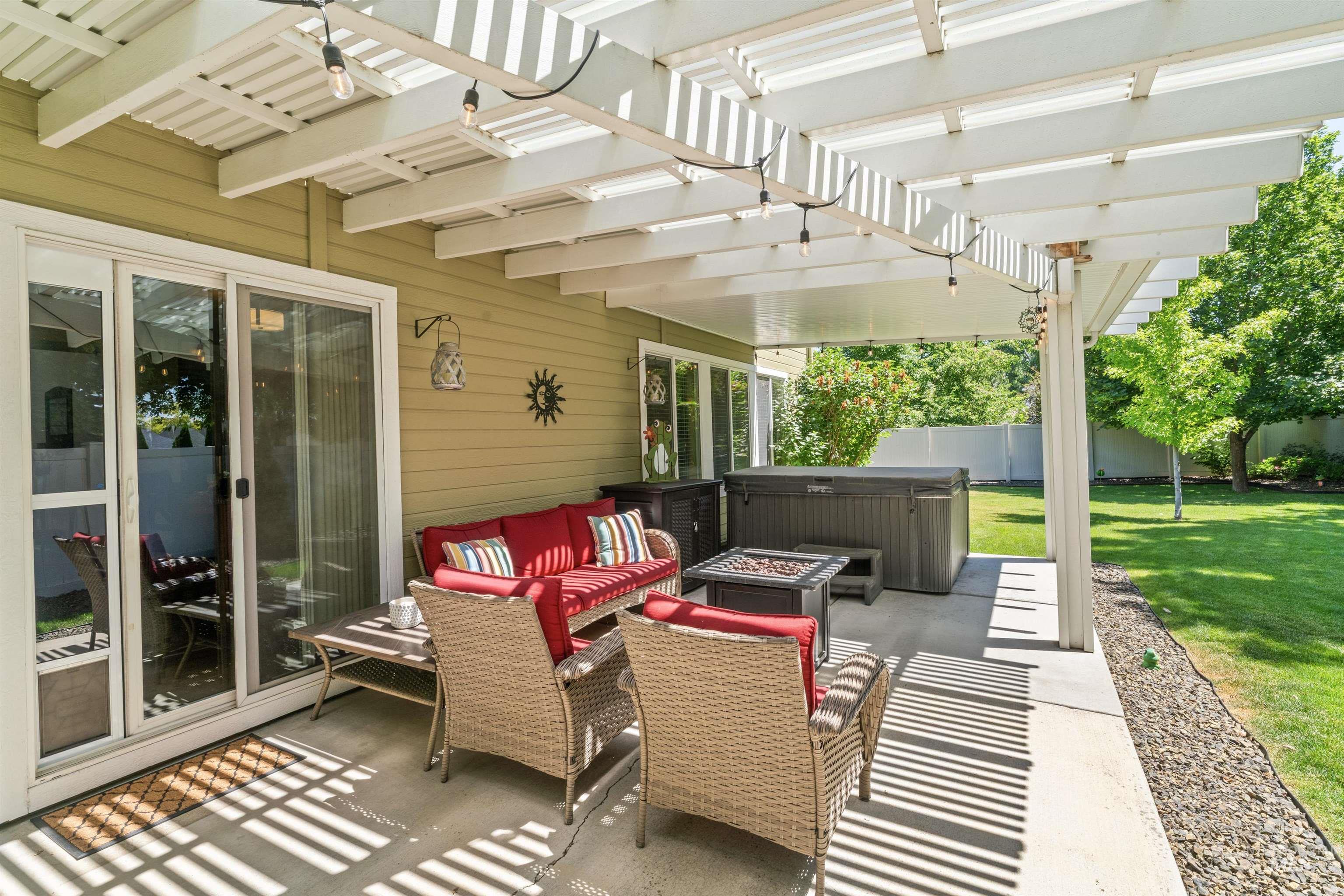 View of patio / terrace featuring a hot tub and a pergola