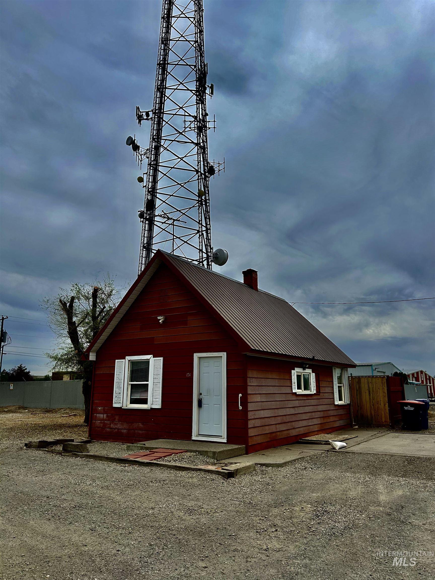 View of front of property with a chimney and a metal roof