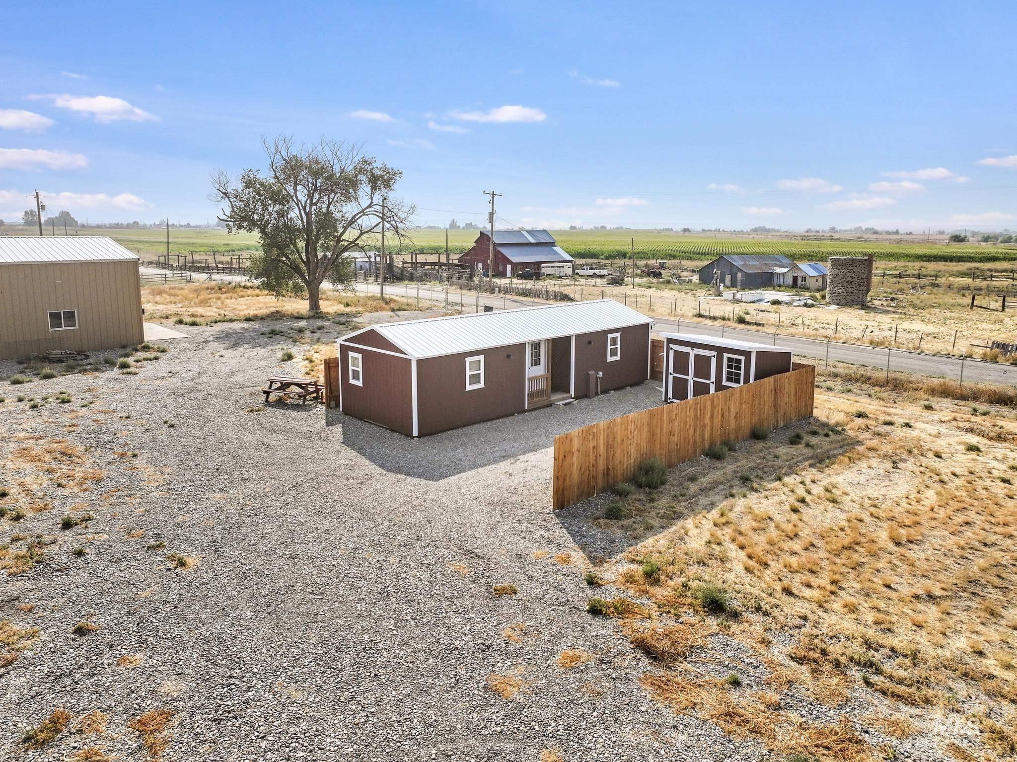 View of front facade featuring a rural view and an outdoor structure