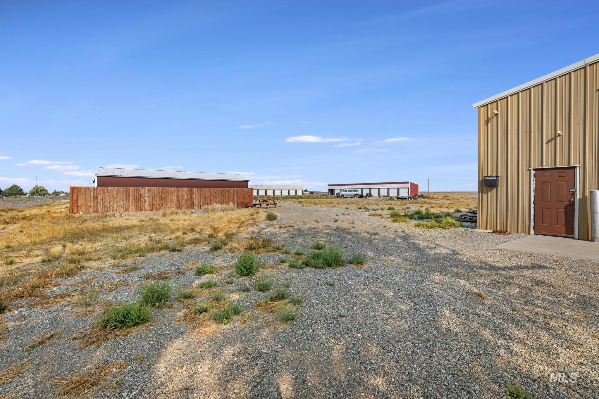 View of yard with a pole building and an outdoor structure