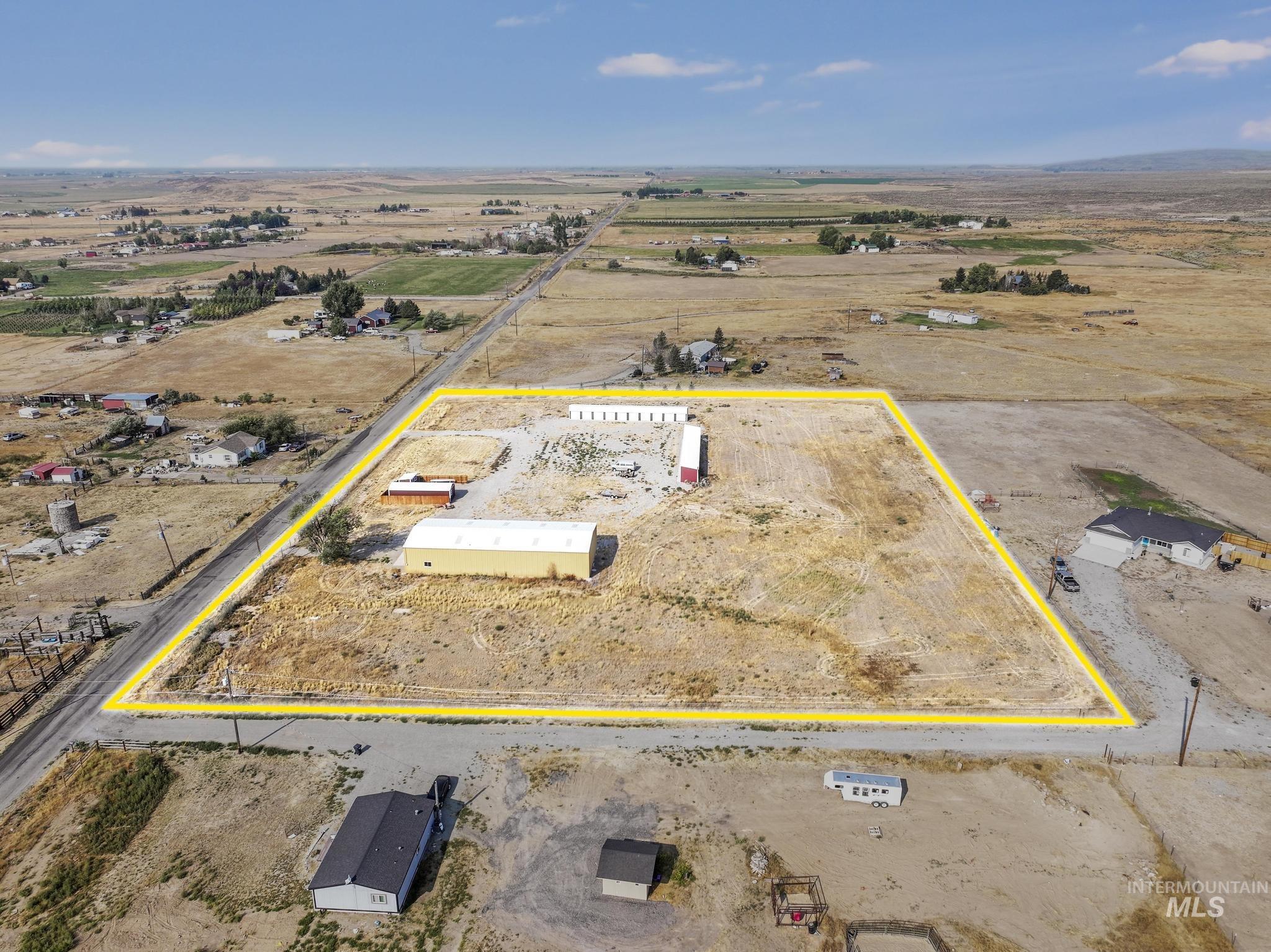 Aerial view of sparsely populated area with property parcel outlined