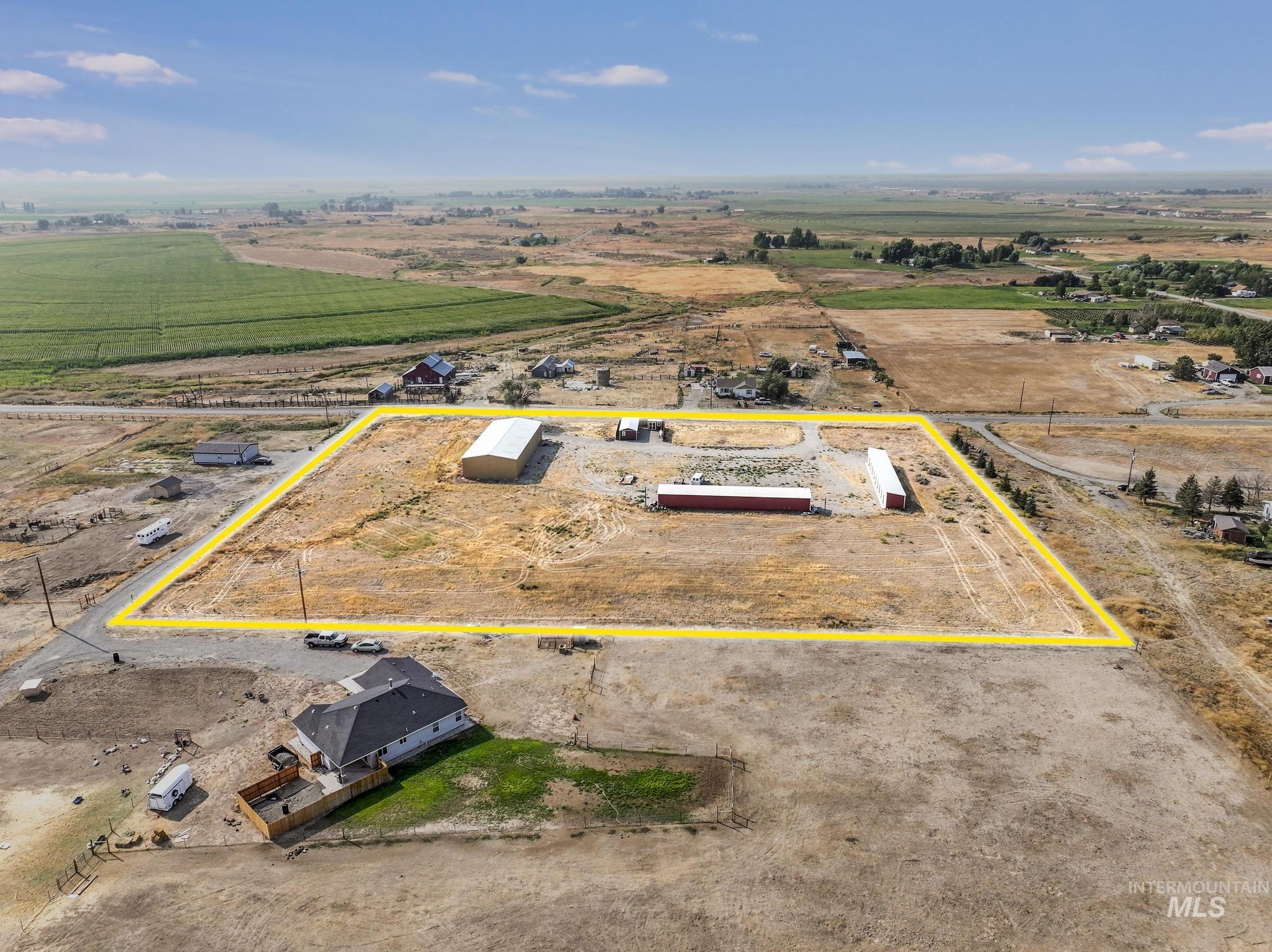 Aerial view of sparsely populated area featuring property parcel outlined