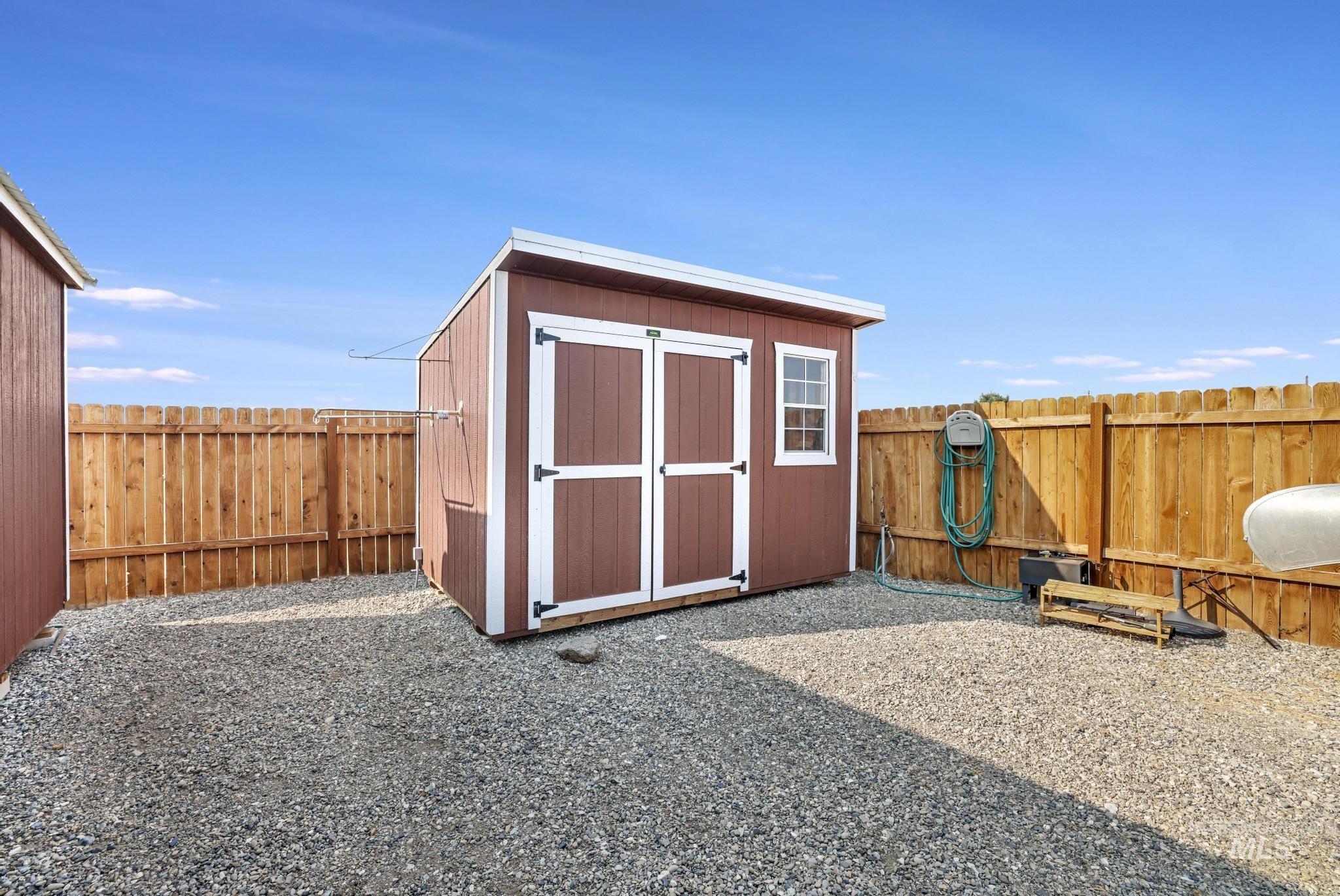 View of shed with a fenced backyard
