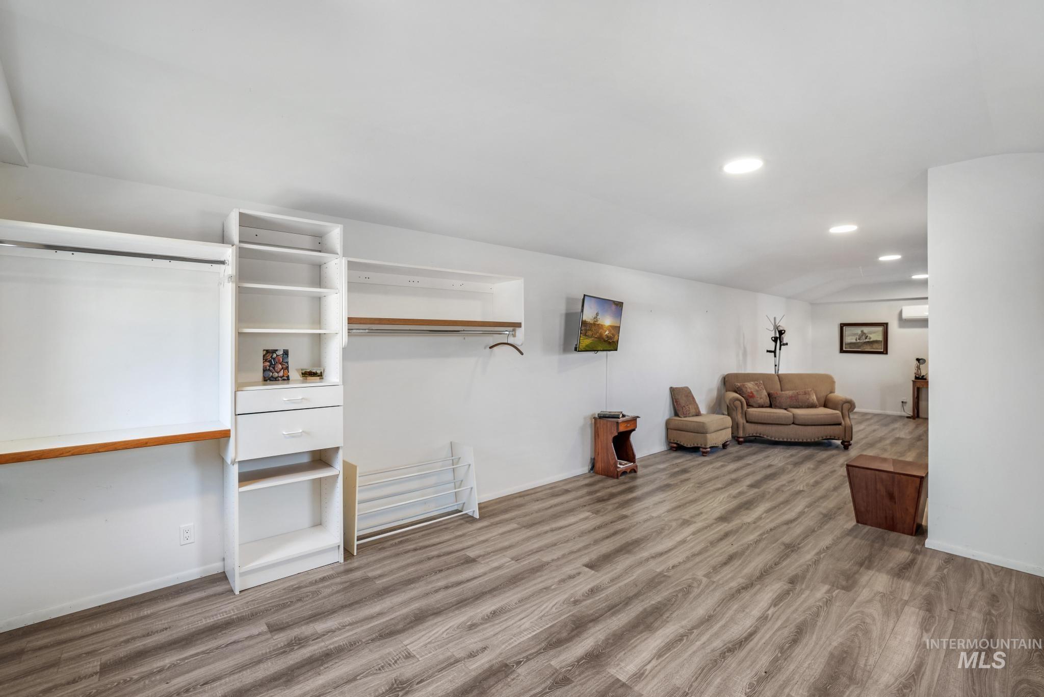Living area featuring light wood-style flooring and recessed lighting