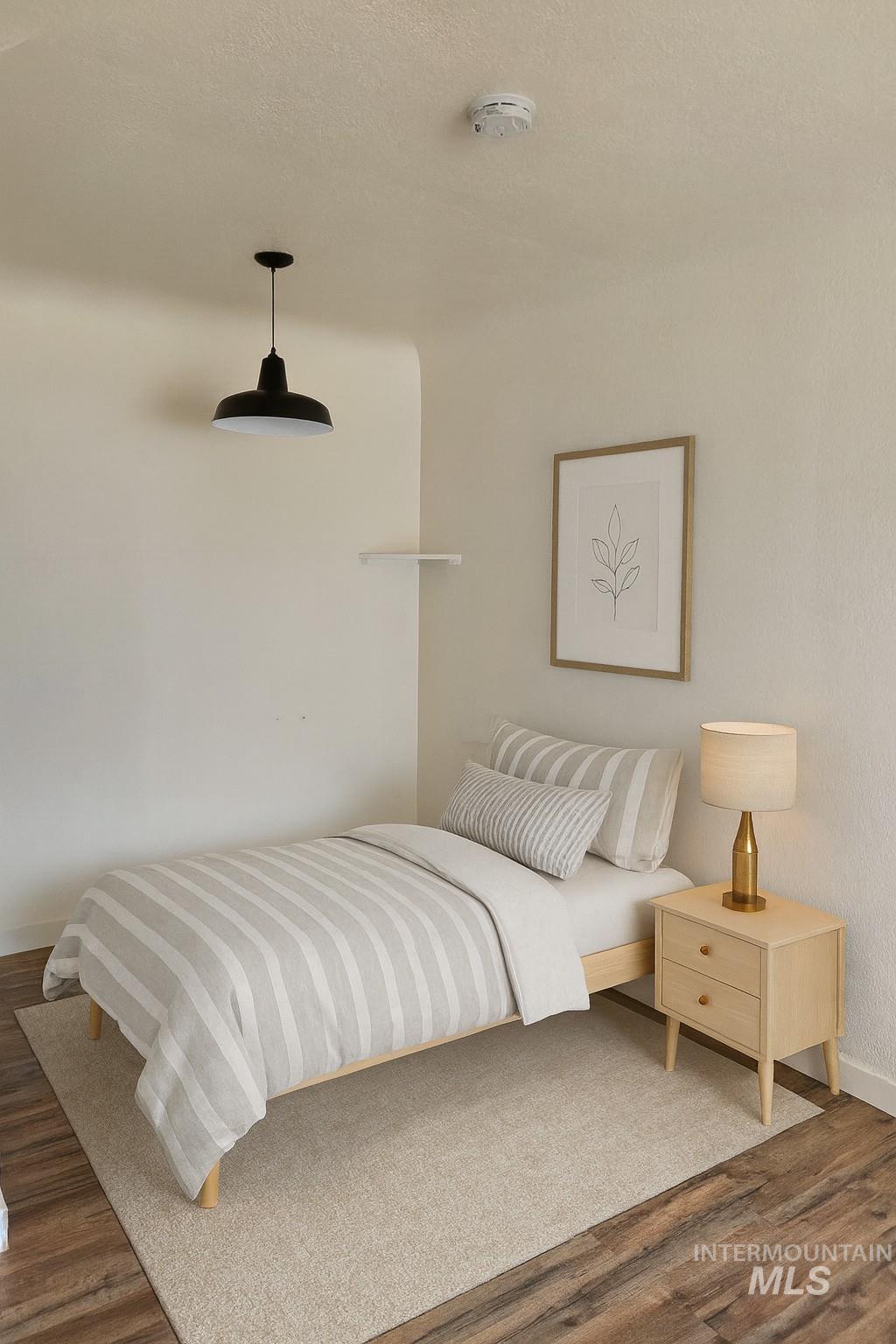 Bedroom with wood finished floors and a ceiling fan