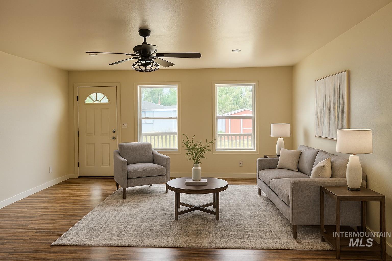 Living area with ceiling fan and wood finished floors